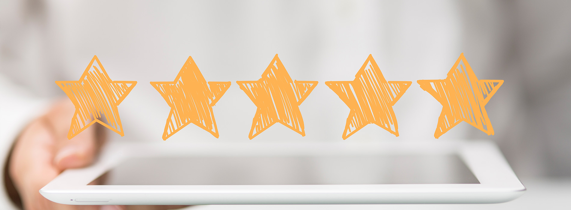 The image shows a hand holding a tablet with a graphic of five orange stars at the top, suggesting high ratings or positive feedback.